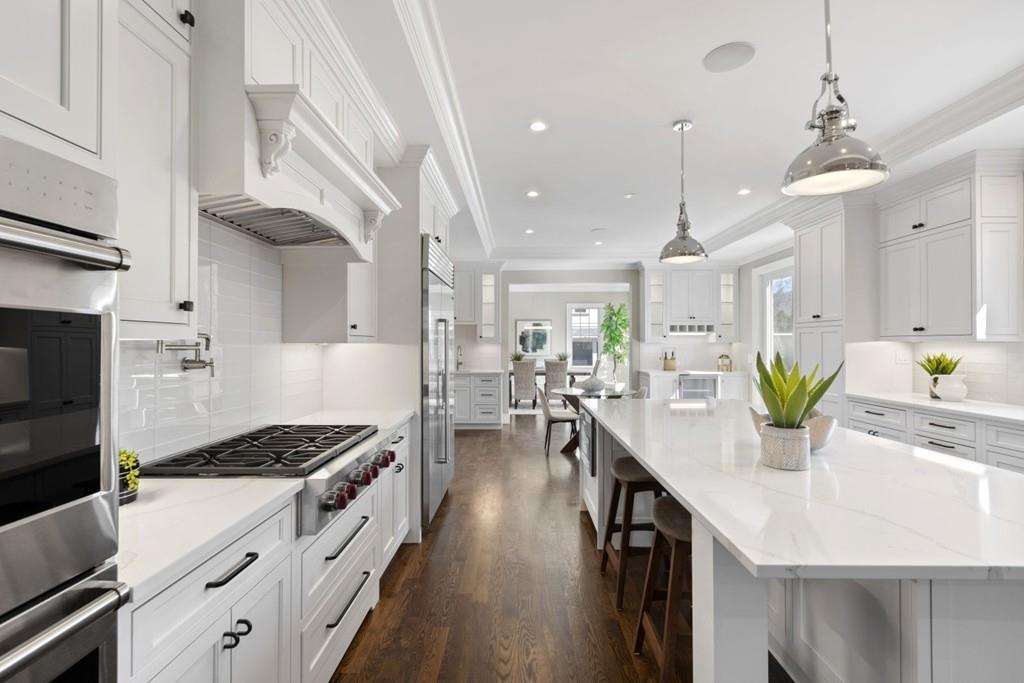 11 Fairhaven Road Newton, MA 02459 - Photo 17 of 40 a kitchen with stainless steel appliances kitchen island granite countertop a lot of counter space and wooden floors