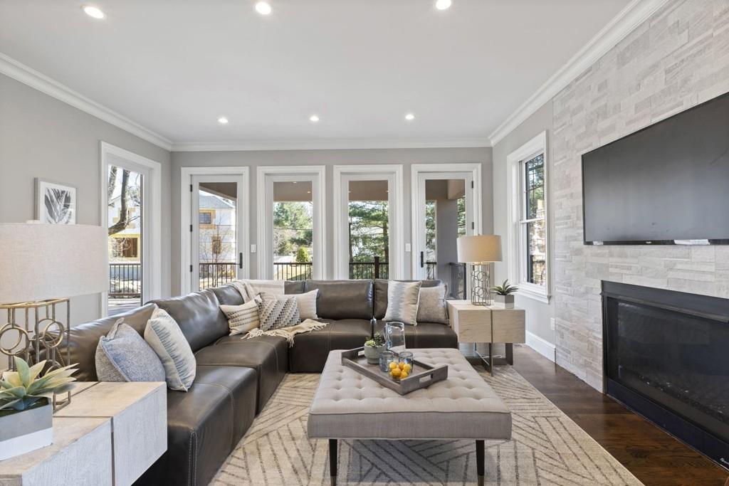 11 Fairhaven Road Newton, MA 02459 - Photo 22 of 40 a living room with furniture flat screen tv and a fireplace