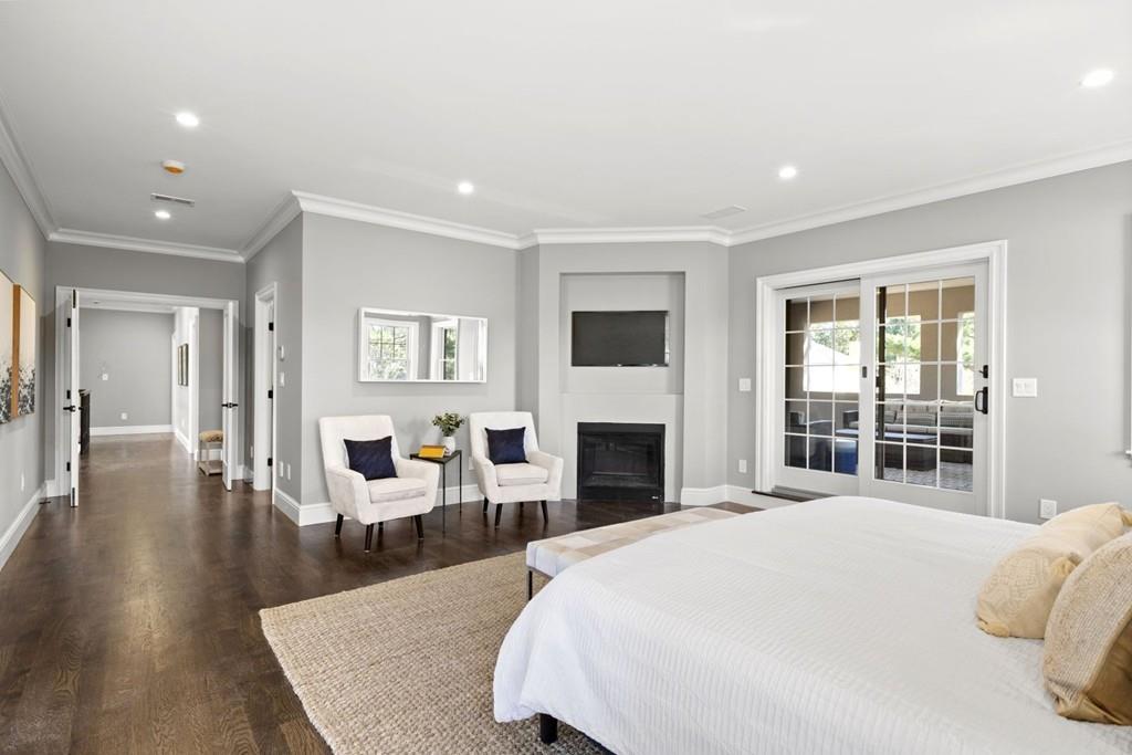 11 Fairhaven Road Newton, MA 02459 - Photo 25 of 40 a spacious bedroom with a balcony a bed and a fireplace