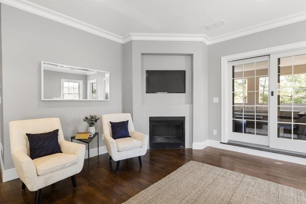 11 Fairhaven Road Newton, MA 02459 - Photo 27 of 40 a living room with furniture a fireplace and a flat screen tv