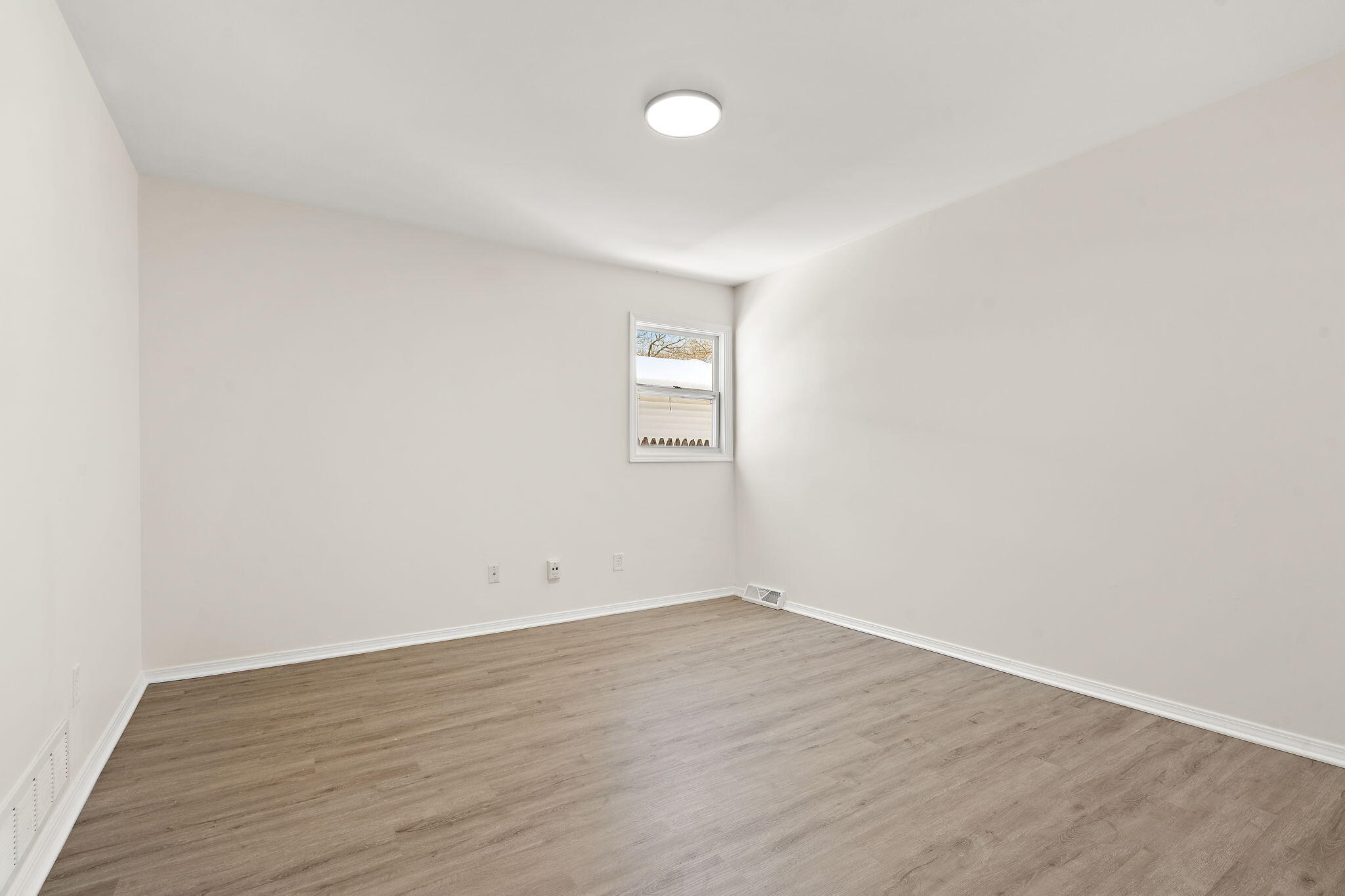 2014 East Elm Street Griffith, IN 46319 - Photo 11 of 14 an empty room with wooden floor and window