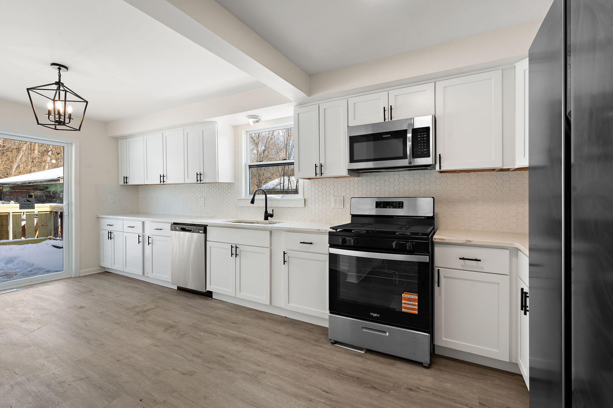 2014 East Elm Street Griffith, IN 46319 - Photo 3 of 14 a kitchen with stainless steel appliances granite countertop a stove a sink and a microwave
