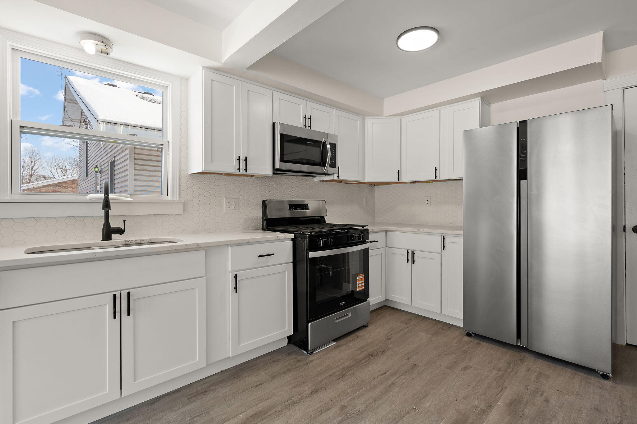 2014 East Elm Street Griffith, IN 46319 - Photo 5 of 14 a kitchen with stainless steel appliances white cabinets and a sink