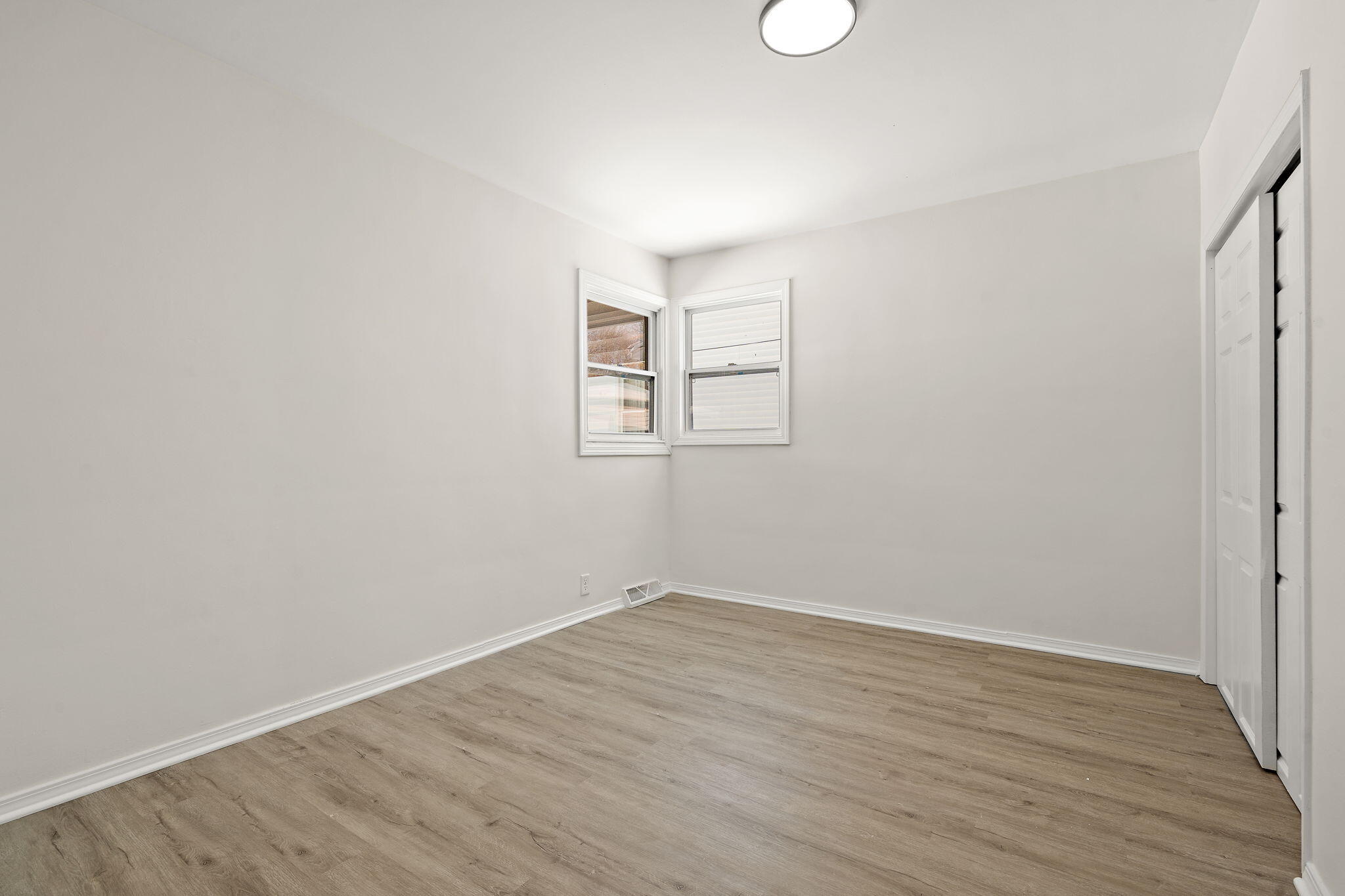 2014 East Elm Street Griffith, IN 46319 - Photo 7 of 14 an empty room with wooden floor and windows