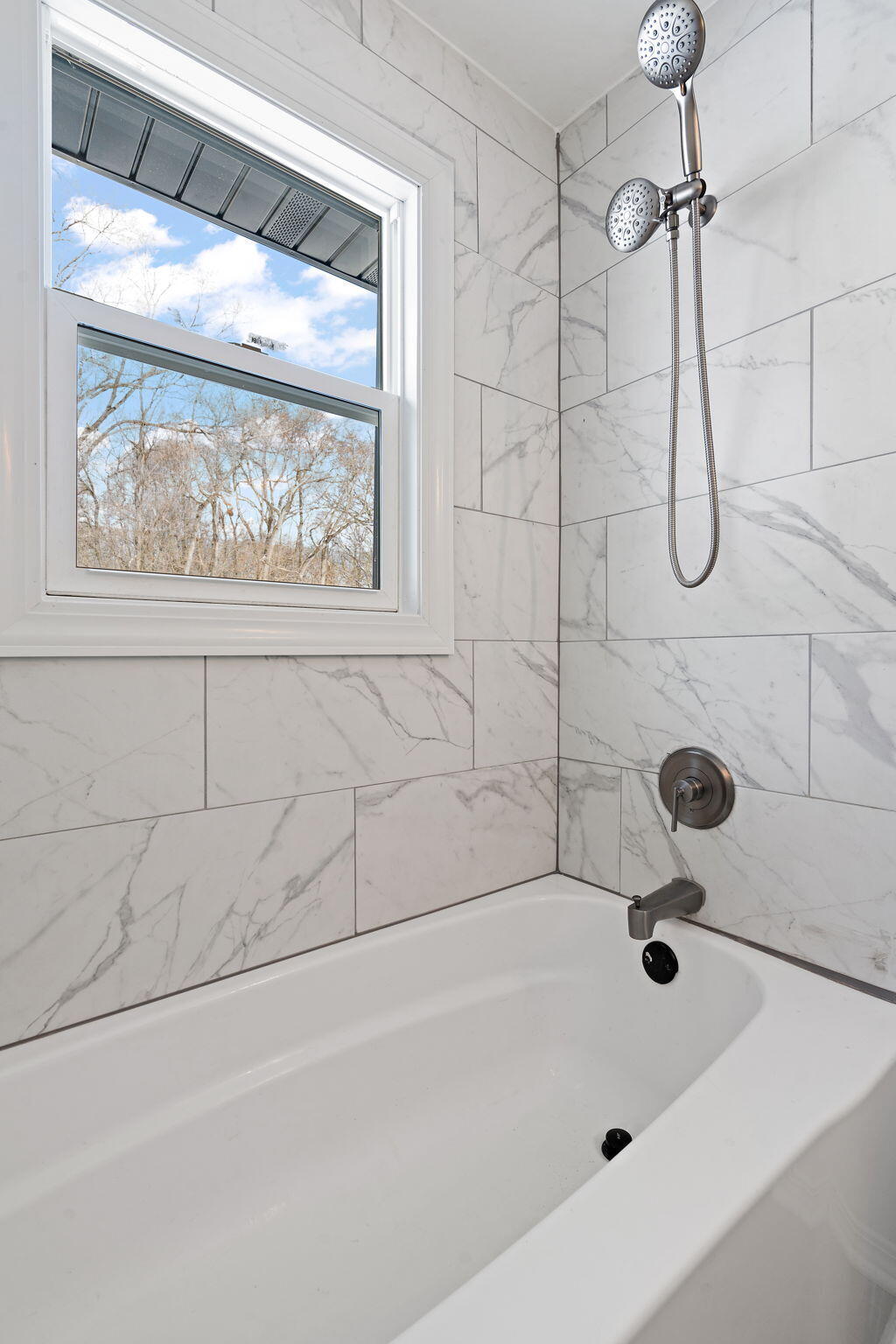 2014 East Elm Street Griffith, IN 46319 - Photo 9 of 14 a bathroom with a bath tub with a shower