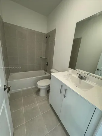 a bathroom with a double vanity sink toilet and shower