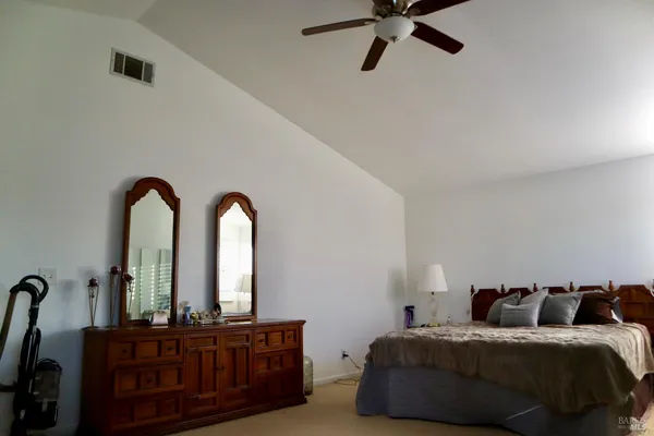 a view of an empty room with furniture and a window