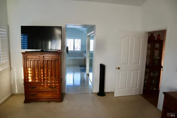 a spacious bathroom with a tub sink and mirror