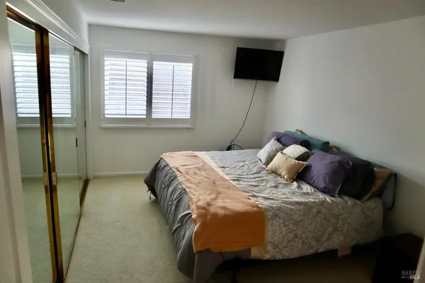 a bedroom with bed and a window