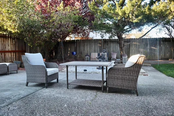 a backyard view with a seating space