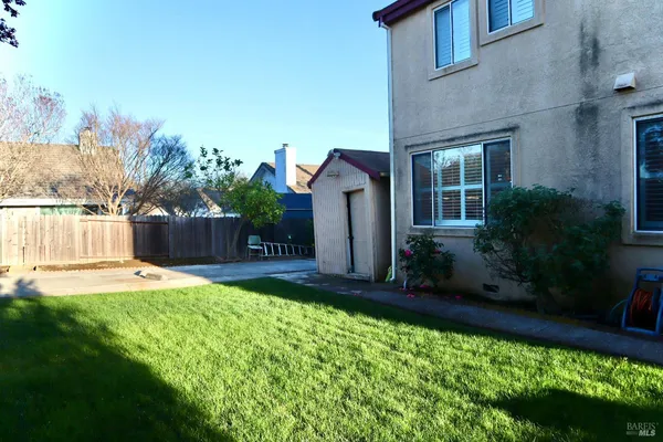 a view of yard with wooden fence