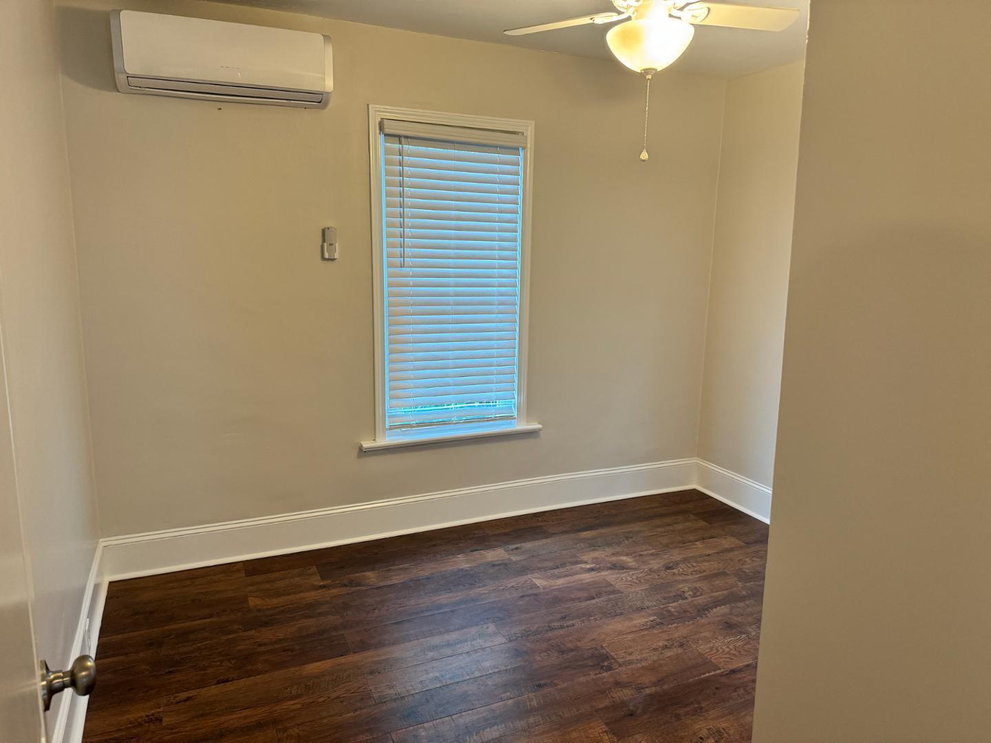 1218 Pender Street Raleigh, NC 27610 - Photo 5 of 21 an empty room with wooden floor and windows