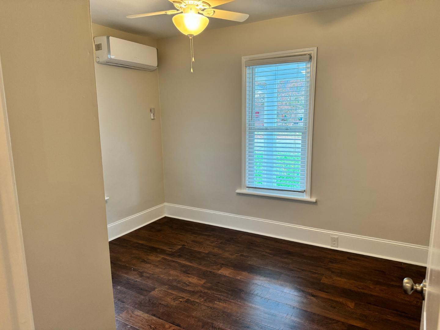 1218 Pender Street Raleigh, NC 27610 - Photo 6 of 21 a view of an empty room with wooden floor and a window