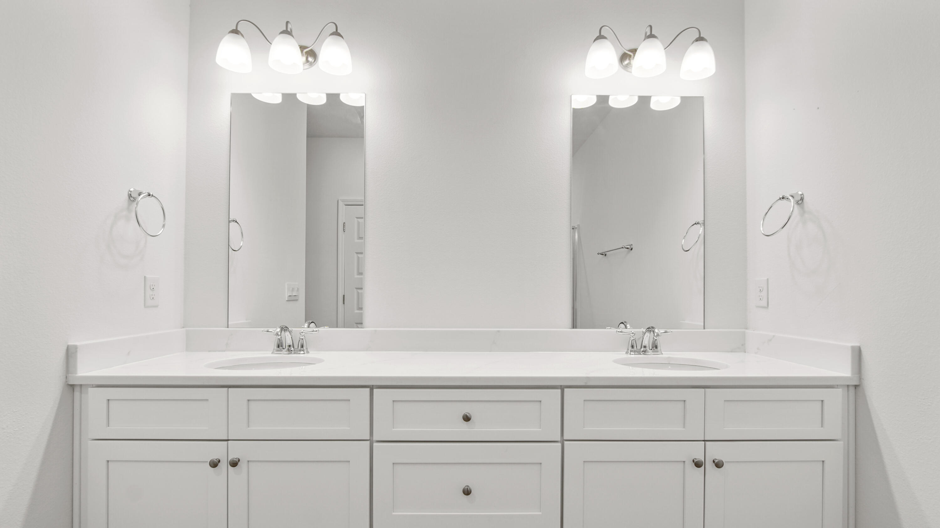 86 Grass Owl Loop Freeport, FL 32439 - Photo 14 of 34 a bathroom with double vanity sinks a vanity a lamp and a mirror