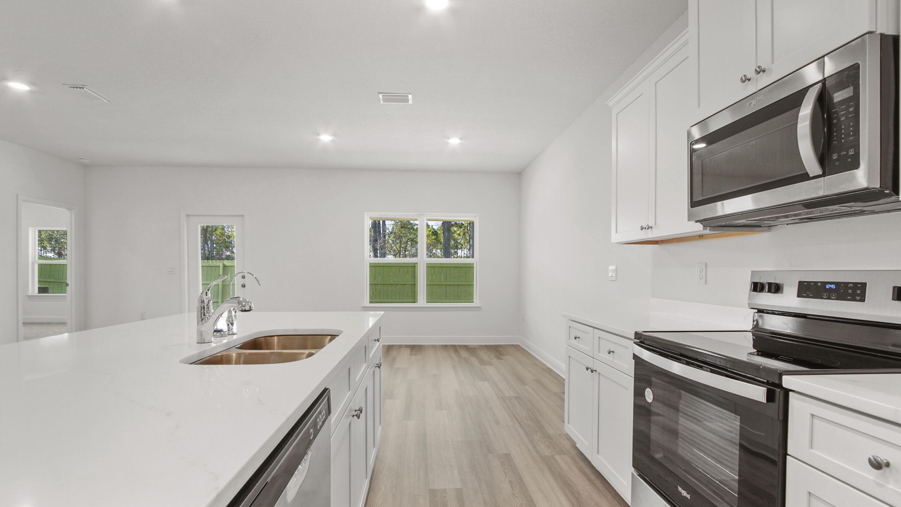 86 Grass Owl Loop Freeport, FL 32439 - Photo 7 of 34 a kitchen with a sink stove and microwave