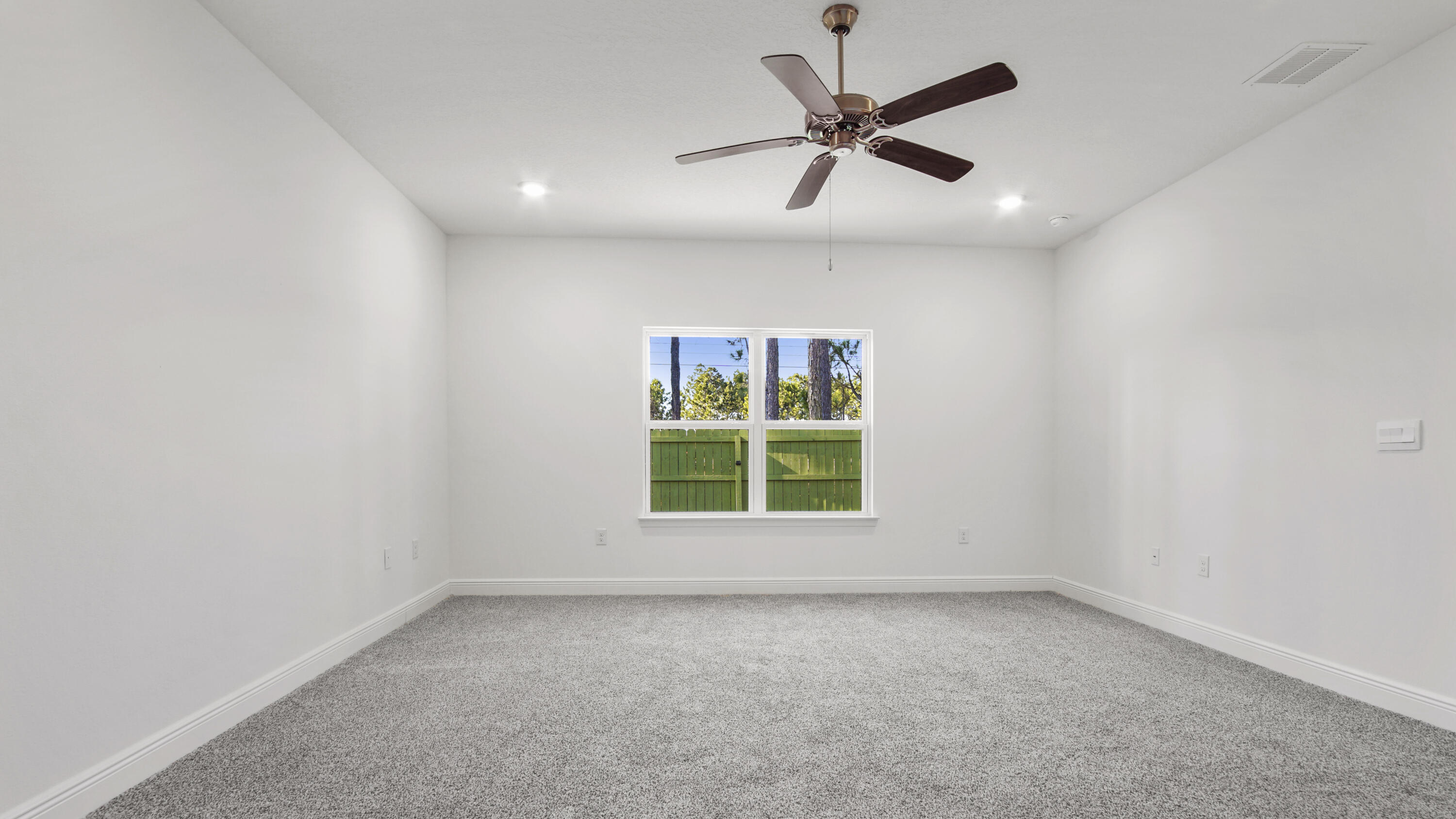 86 Grass Owl Loop Freeport, FL 32439 - Photo 10 of 34 an empty room with a window and a fan