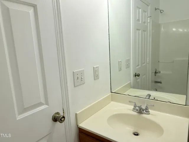 a view of a kitchen with kitchen island wooden floor and a ceiling fan
