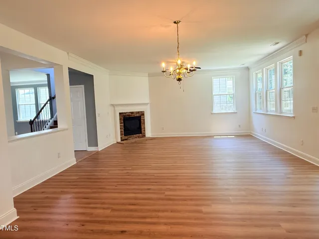 a view of a hallway with wooden floor and entryway