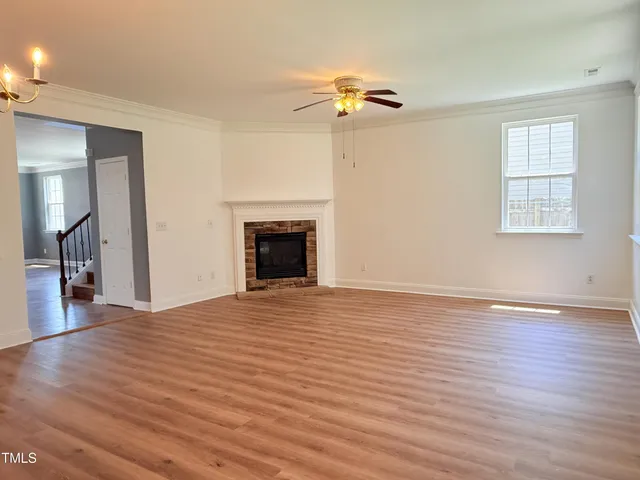 a view of a room with wooden floor and a window