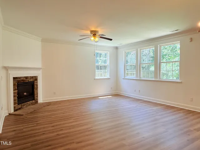 a view of a room with wooden floor and window