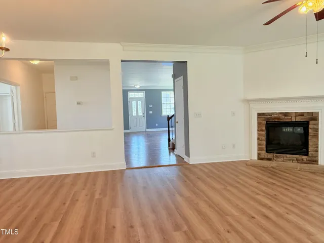 a view of a room with wooden floor