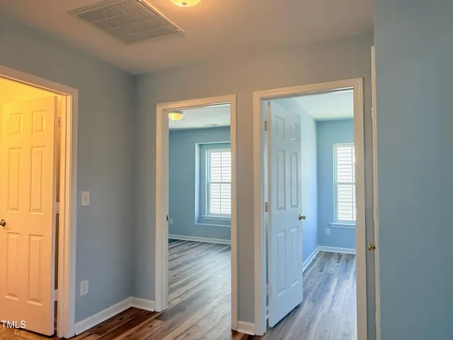 a view of a room with wooden floor and fan