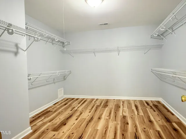 a yellow house with trees in front of it