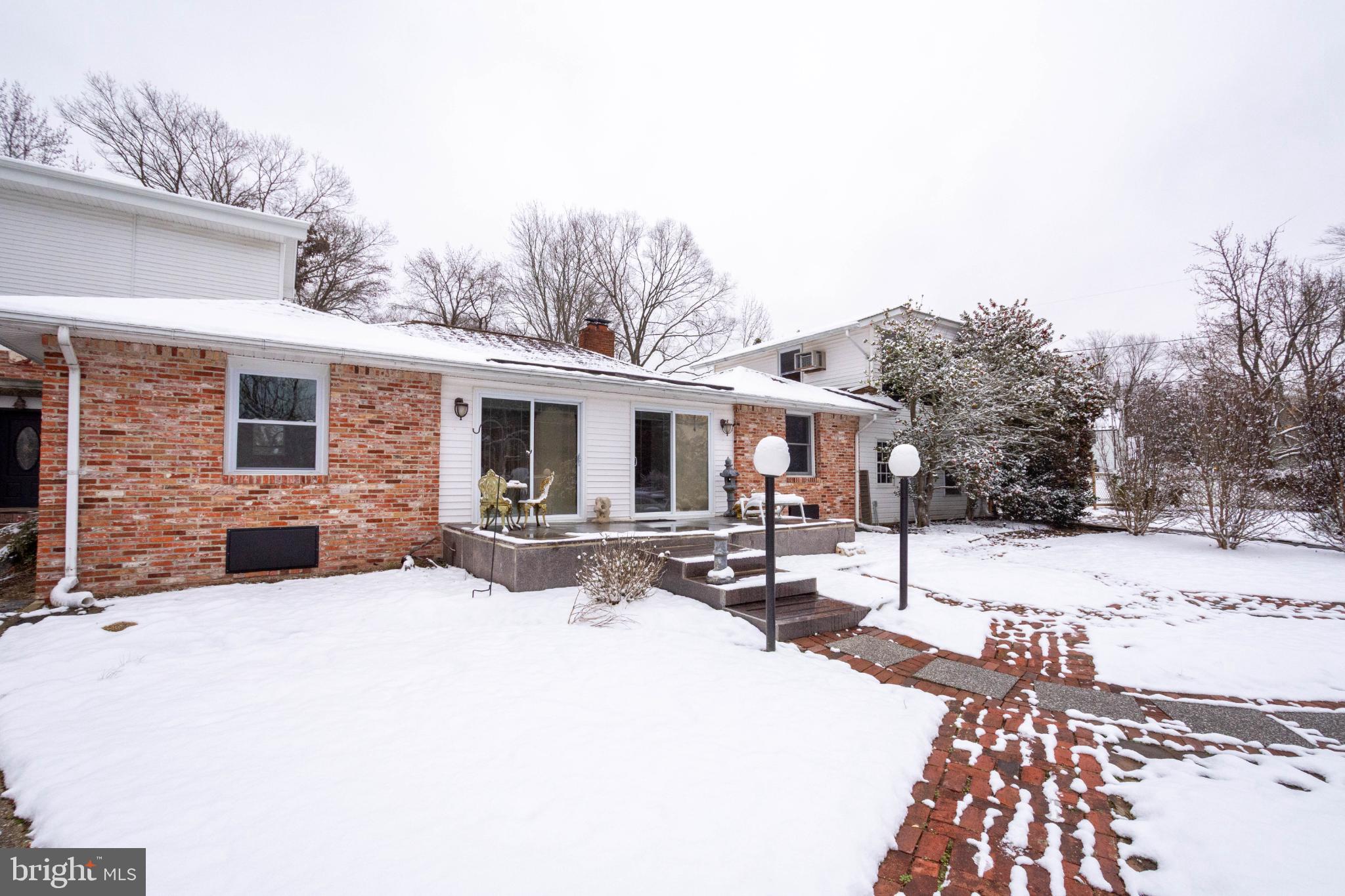 a view of a house with snow on the road