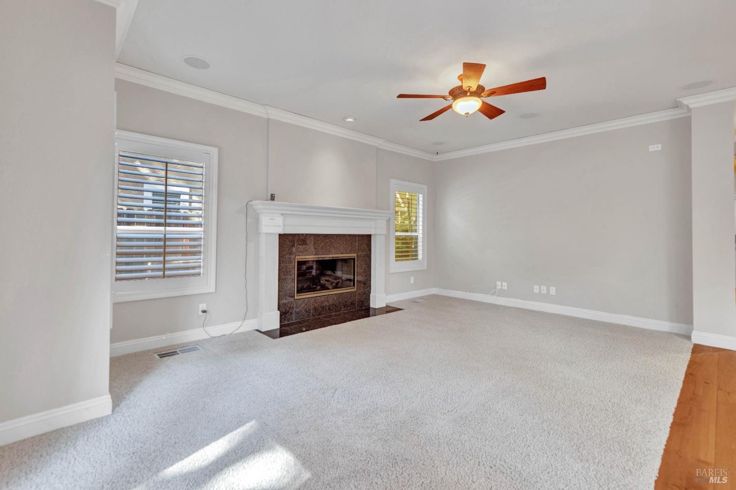 3229 Seminole Circle Fairfield, CA 94534 - Photo 22 of 73 an empty room with windows fireplace and fan
