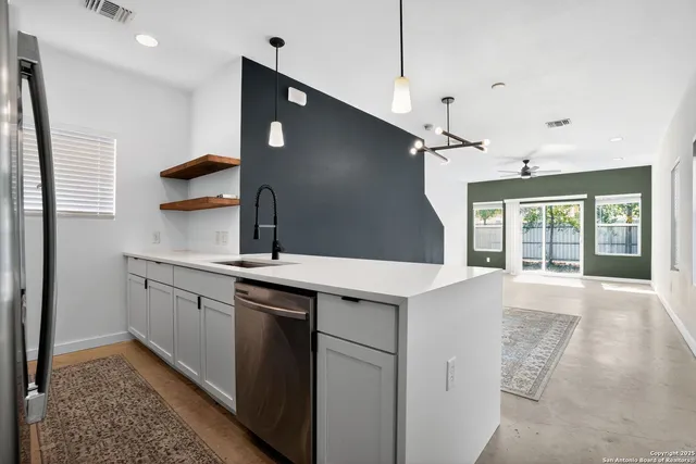 a kitchen with a sink stove and cabinets