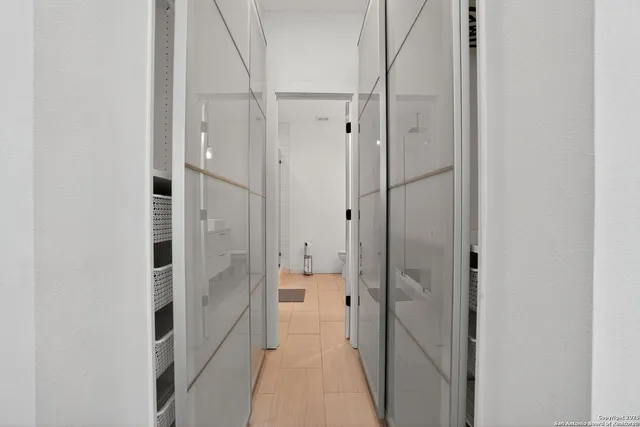 a bathroom with a shower and a glass door