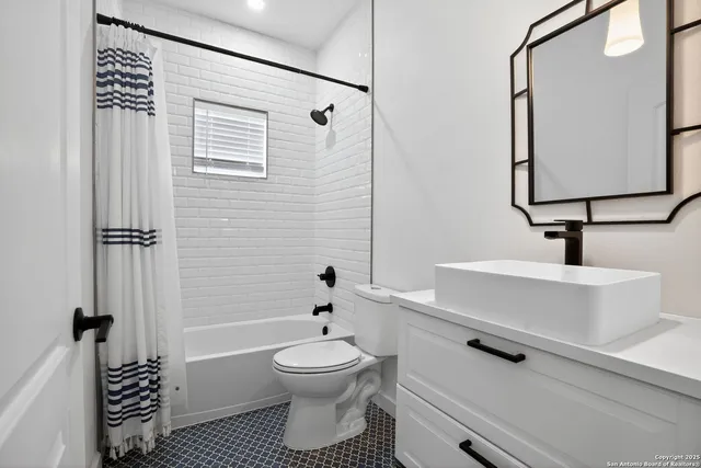 a bathroom with a toilet a sink and shower