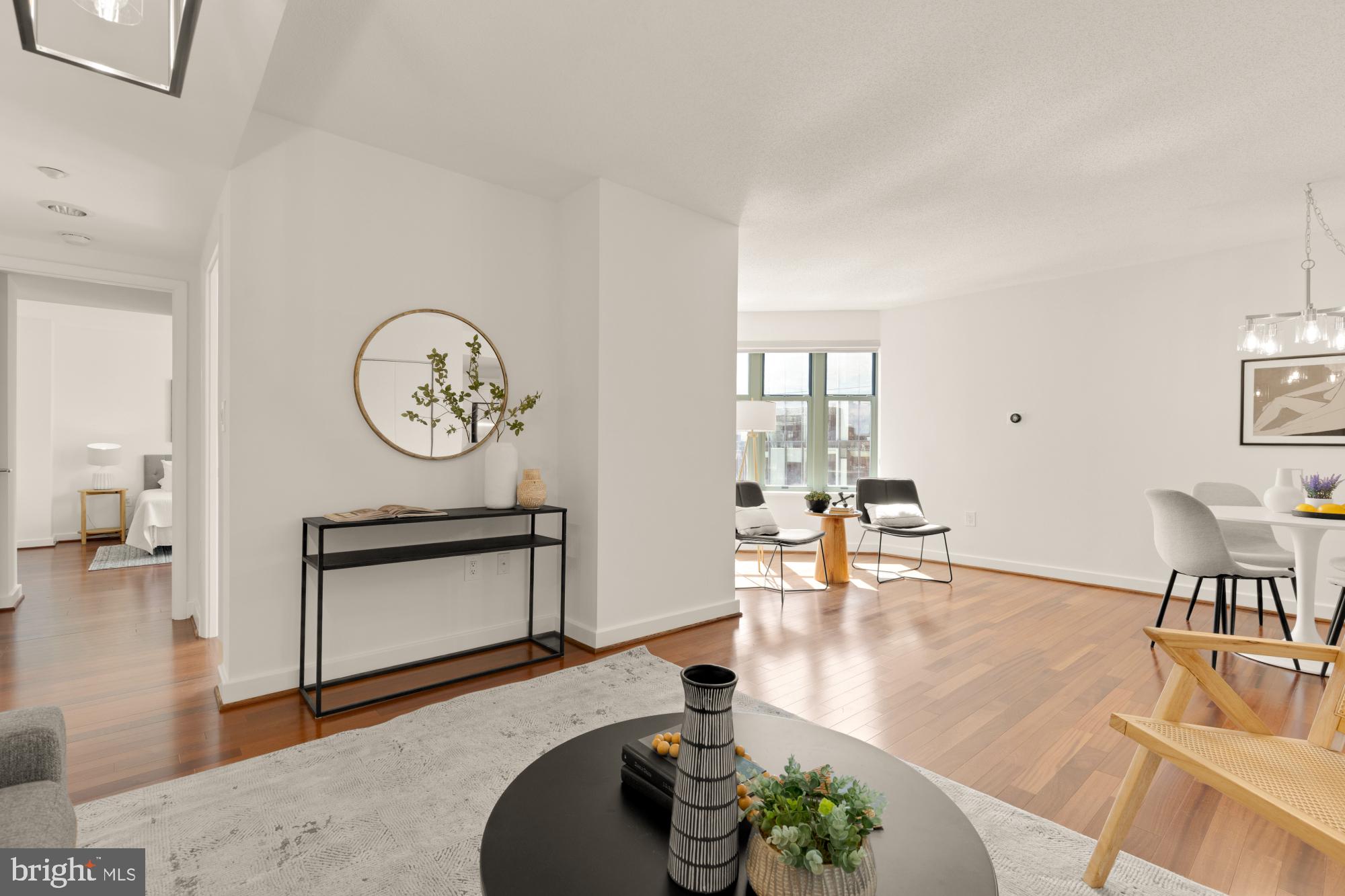 a living room with furniture a clock on wall and a table