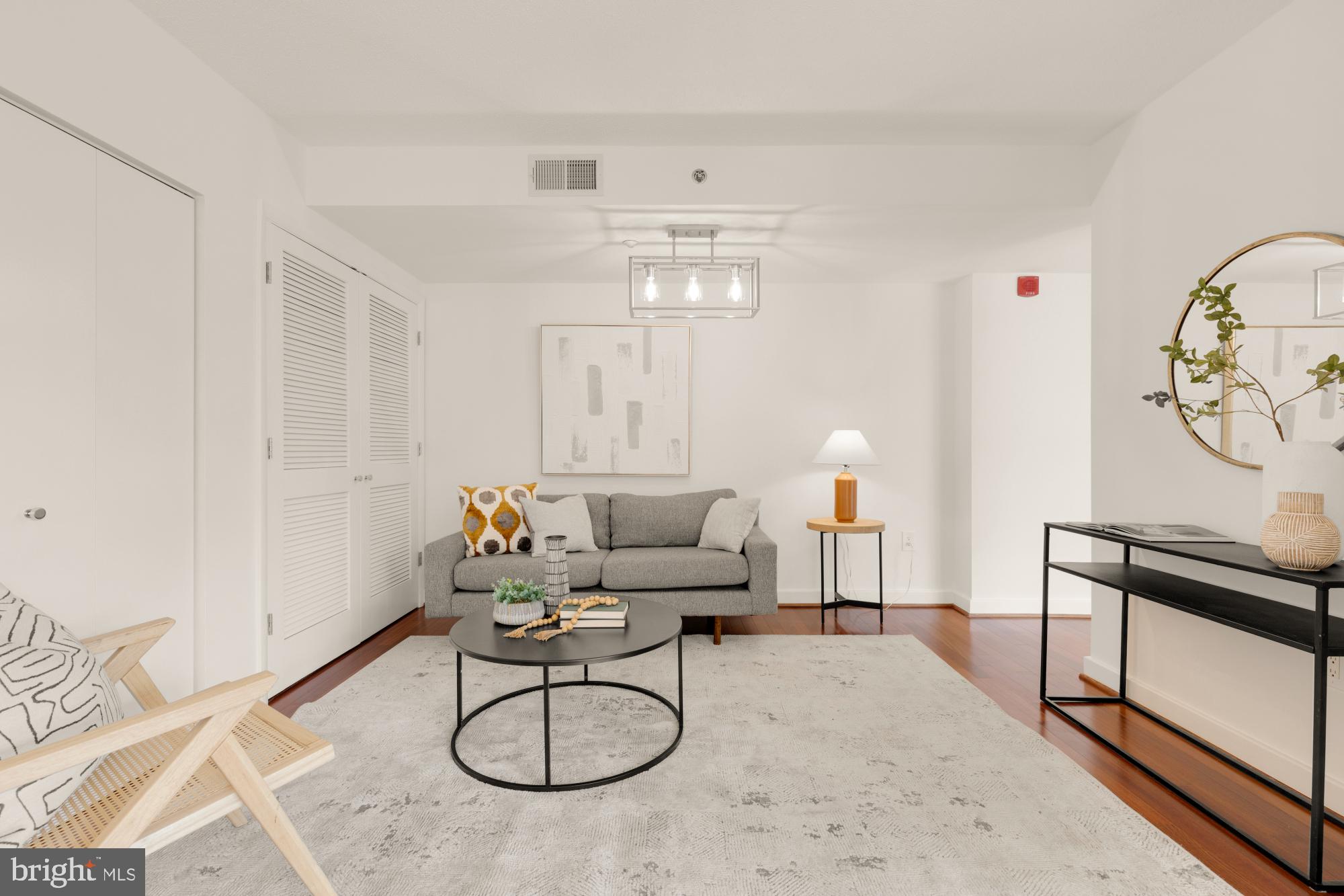 1150 K Street Northwest, Unit 1211 Washington, DC 20005 - Photo 11 of 29 a living room with furniture chandelier and a stove