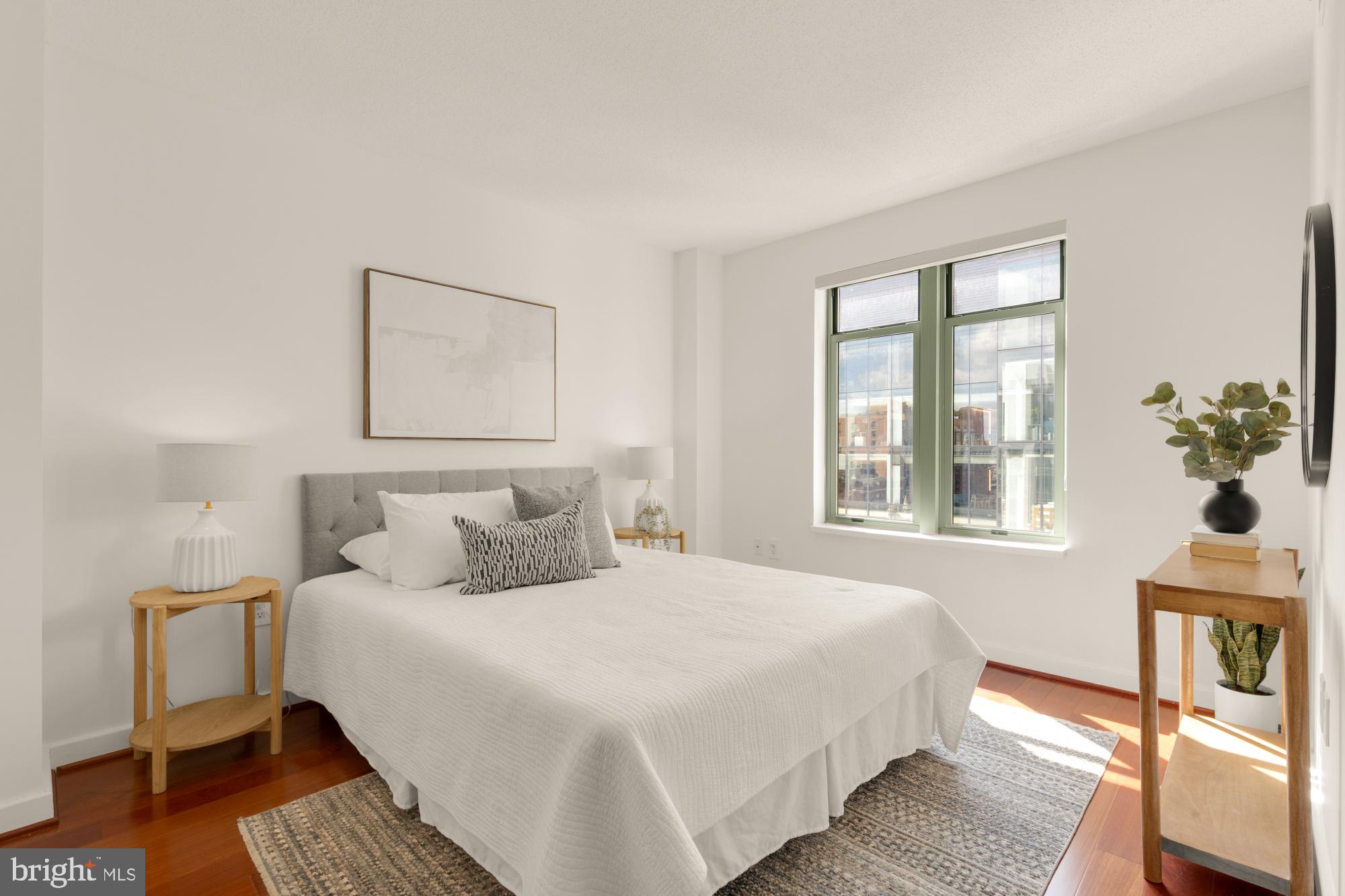 1150 K Street Northwest, Unit 1211 Washington, DC 20005 - Photo 14 of 29 a bedroom with a bed and wooden floor