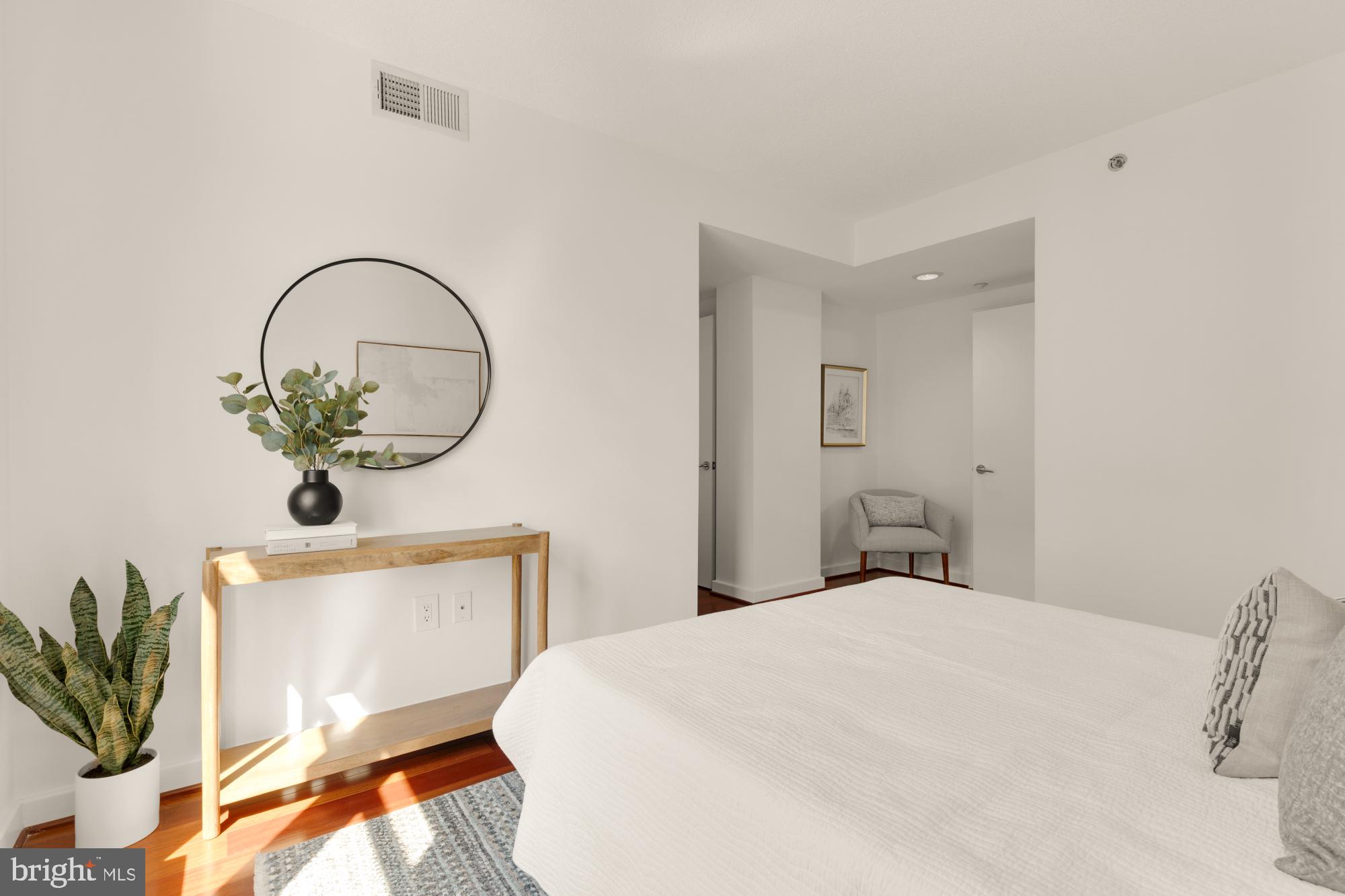 1150 K Street Northwest, Unit 1211 Washington, DC 20005 - Photo 15 of 29 a bedroom with a bed and a potted plant
