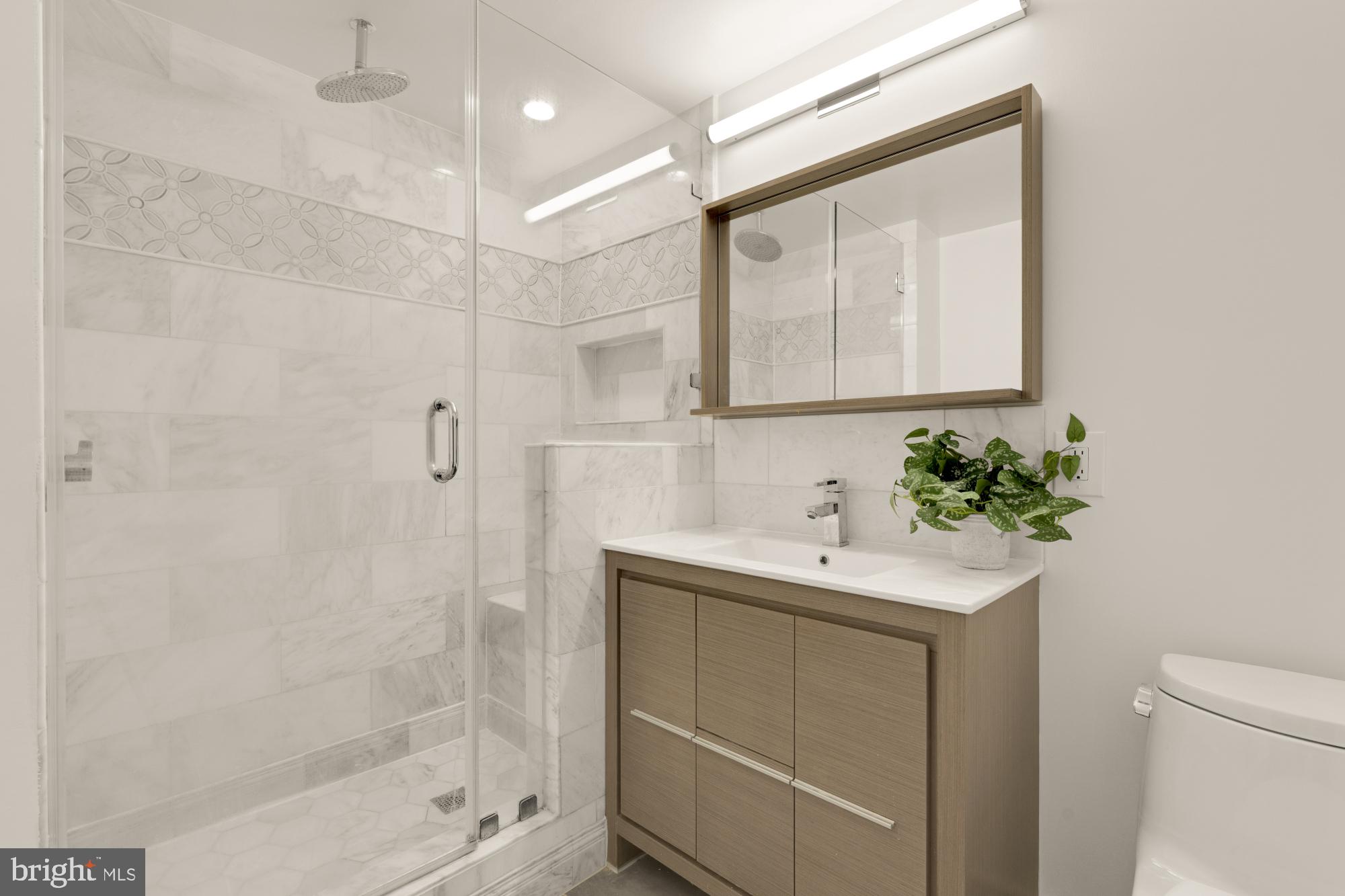 1150 K Street Northwest, Unit 1211 Washington, DC 20005 - Photo 17 of 29 a bathroom with a sink a shower and a mirror