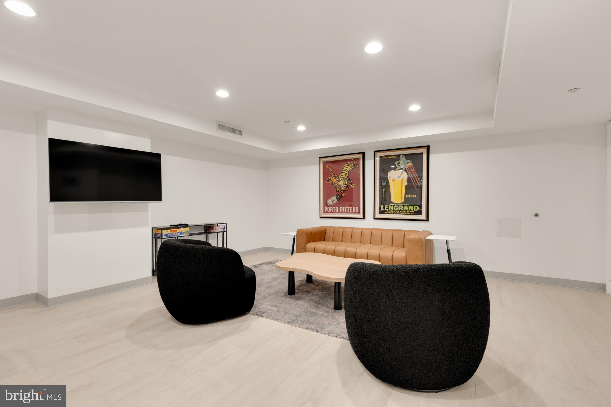 1150 K Street Northwest, Unit 1211 Washington, DC 20005 - Photo 24 of 29 a living room with furniture and a flat screen tv