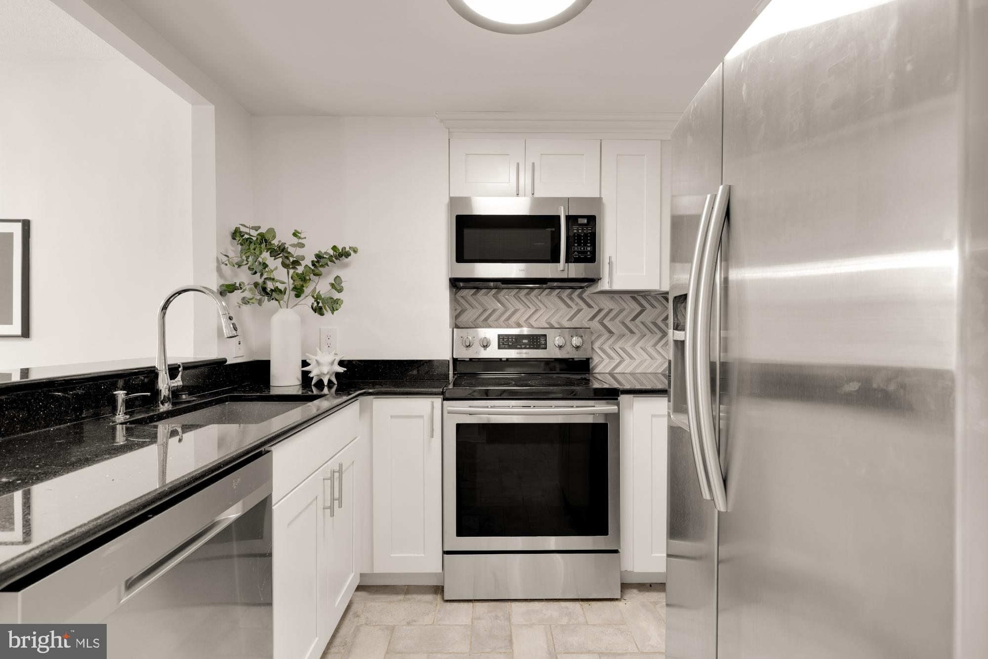 1150 K Street Northwest, Unit 1211 Washington, DC 20005 - Photo 3 of 29 a kitchen with a sink stove and microwave