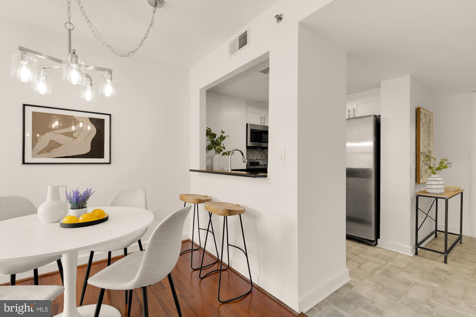 1150 K Street Northwest, Unit 1211 Washington, DC 20005 - Photo 5 of 29 a view of a dining room with furniture and a chandelier