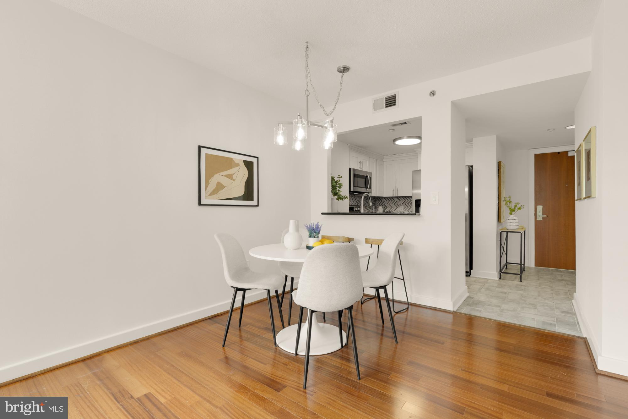 1150 K Street Northwest, Unit 1211 Washington, DC 20005 - Photo 6 of 29 a view of a dining room with furniture and wooden floor