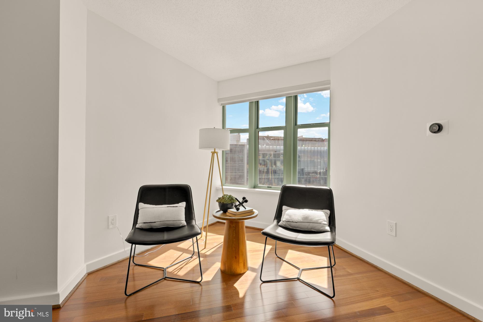 1150 K Street Northwest, Unit 1211 Washington, DC 20005 - Photo 9 of 29 a room with a chair and wooden floor
