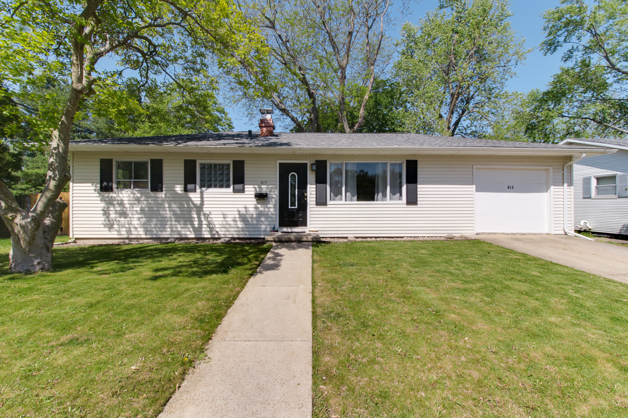 a front view of house with yard and green space