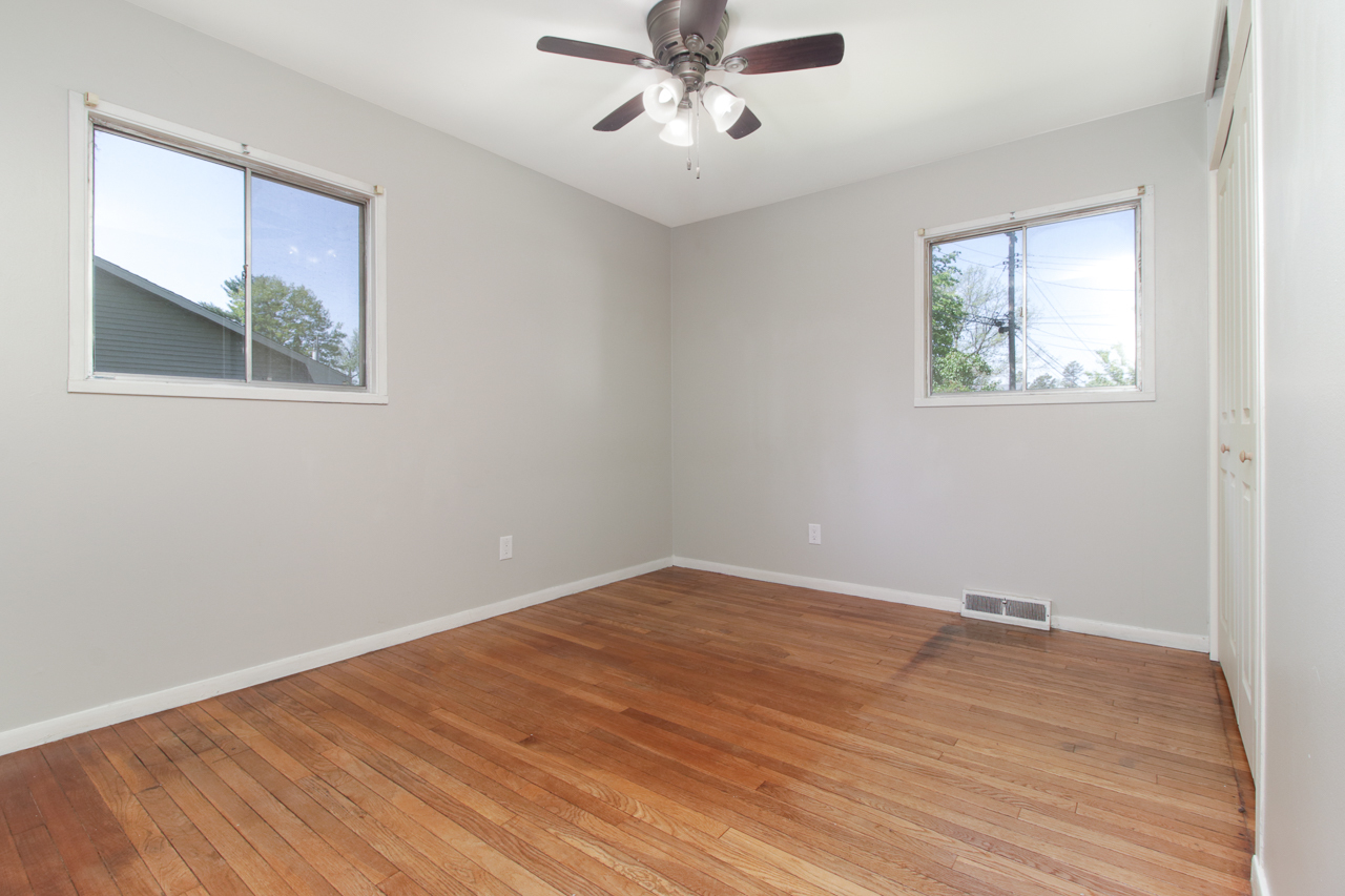 813 Parmon Road Bloomington, IL 61701 - Photo 12 of 23 a view of an empty room with a window and wooden floor