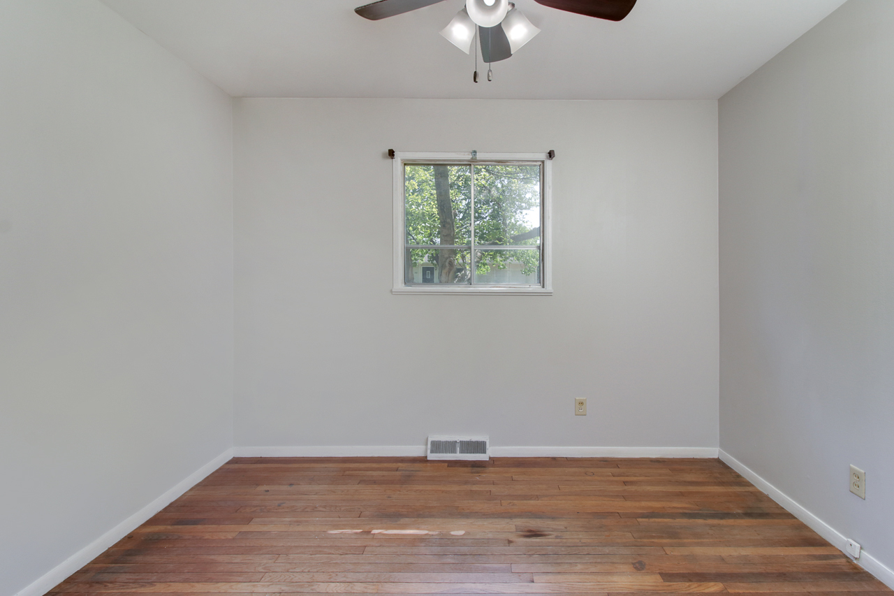 813 Parmon Road Bloomington, IL 61701 - Photo 15 of 23 a view of an empty room with wooden floor and a window