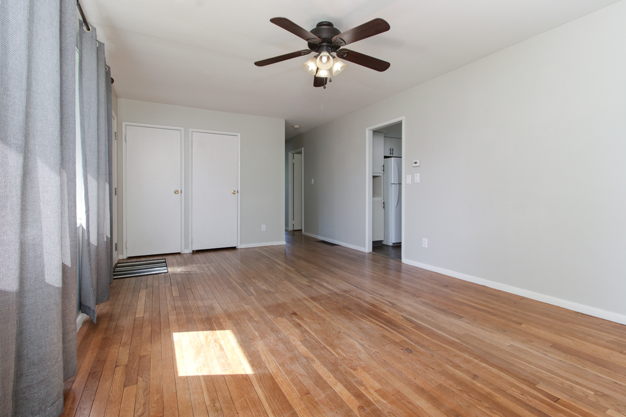 813 Parmon Road Bloomington, IL 61701 - Photo 2 of 23 a view of empty room with wooden floor and fan