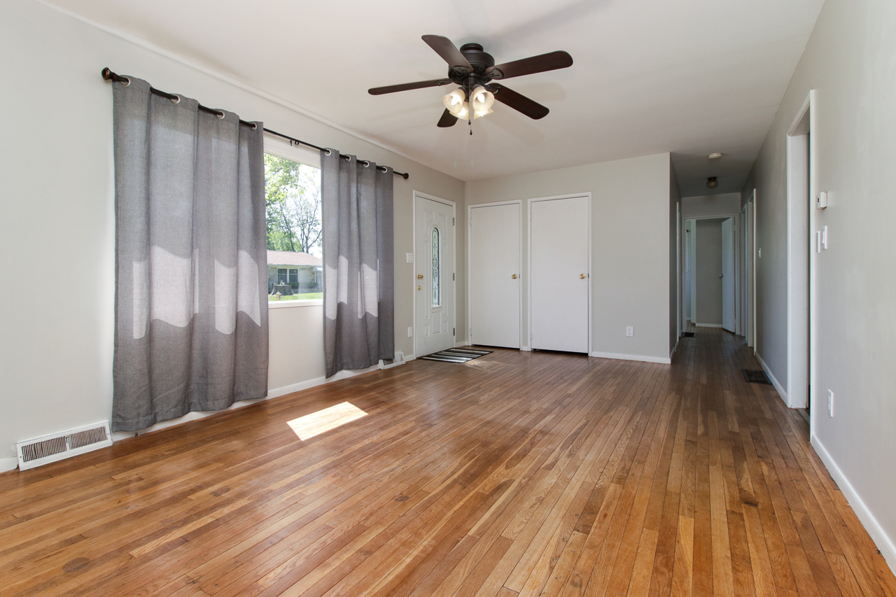 813 Parmon Road Bloomington, IL 61701 - Photo 3 of 23 a view of empty room with wooden floor and fan