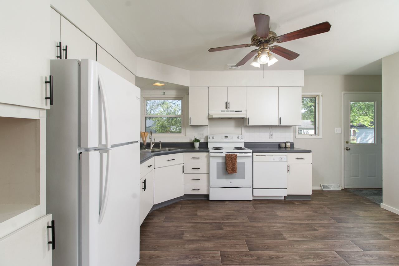 813 Parmon Road Bloomington, IL 61701 - Photo 5 of 23 a kitchen with white cabinets and white appliances