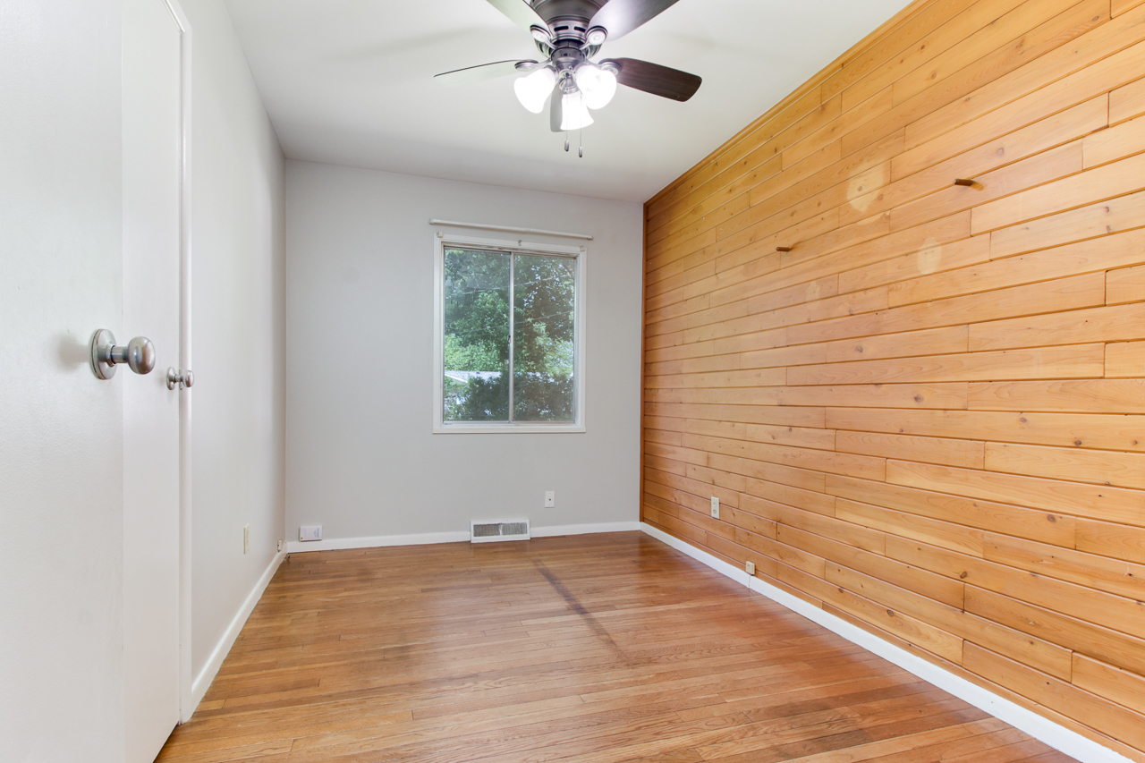 813 Parmon Road Bloomington, IL 61701 - Photo 9 of 23 a view of empty room with wooden floor and fan