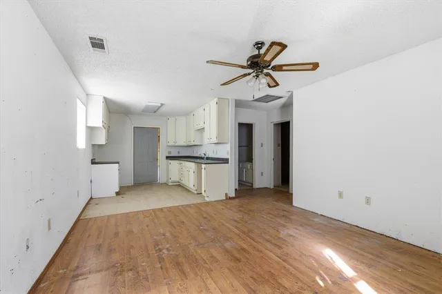 a view of a kitchen with sink and stainless steel appliances